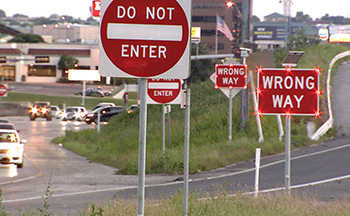 Flashing LED Wrong Way signs in use along a stretch of freeway.