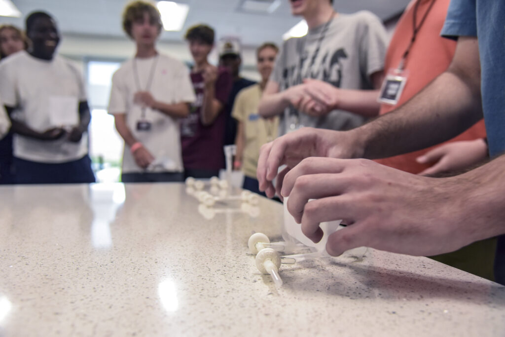 During Camp Build, students participate in a hands-on learning activity where they build and race puff mobiles, putting their creative and problem-solving skills to the test.